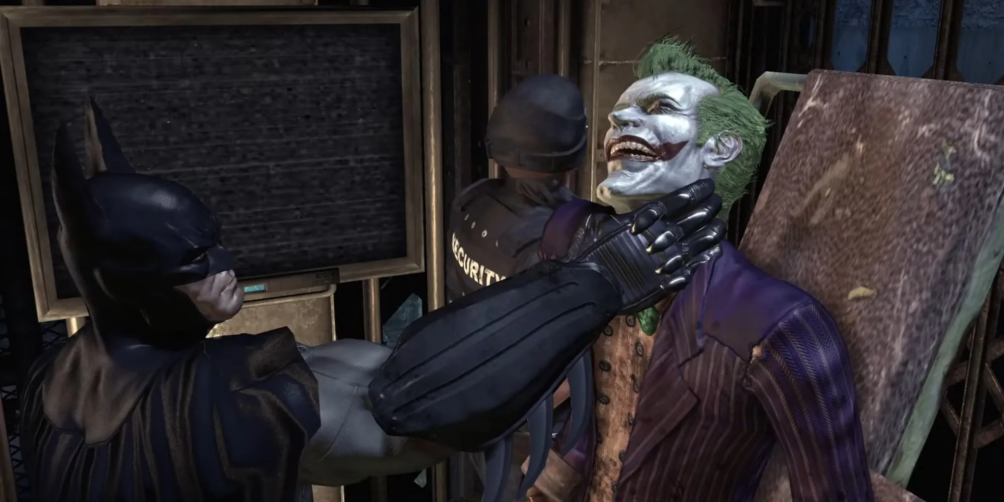 Batman nắm cổ Joker khi hắn được vận chuyển đến buồng giam trong Batman Arkham Asylum