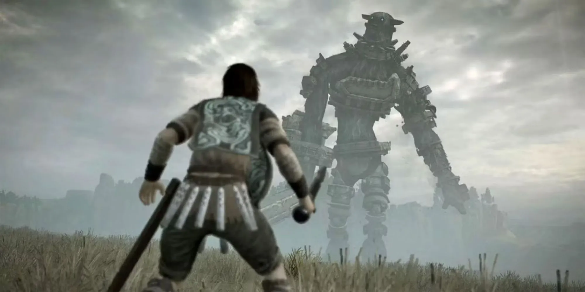 Wander đối diện với một Colossus khổng lồ trong khung cảnh hoang tàn của Shadow of the Colossus